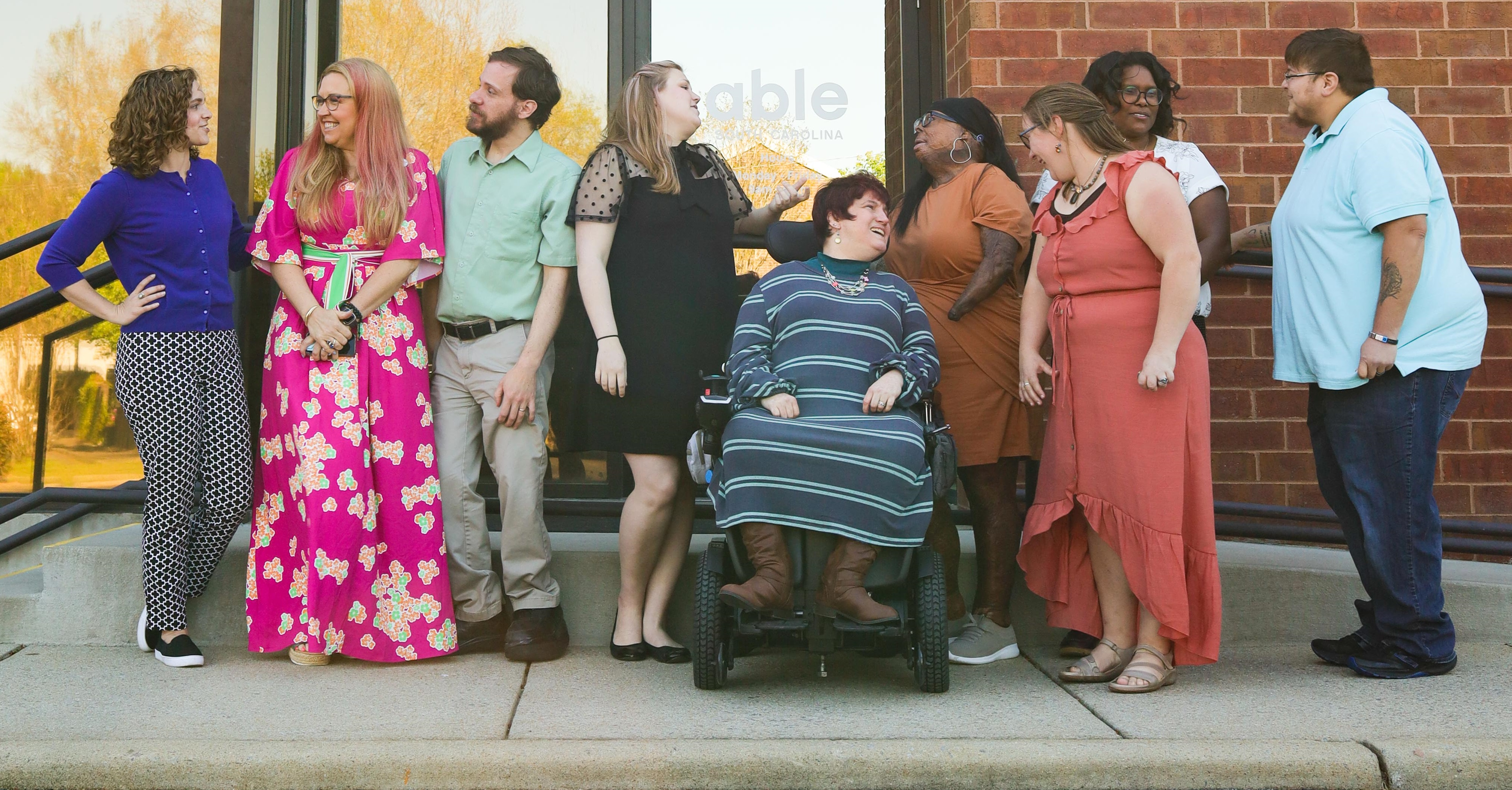 Able SC staff pose with consumers outside the Able SC office.