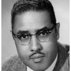 Black and white headshot of Dr. Henderson, a Black man with a mustache and glasses.